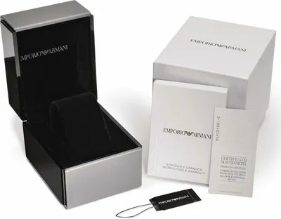 An open watch box, a closed box, and some documentation are arranged on a white background.