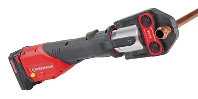 A cordless pipe pressing tool with a copper pipe fitting attached.
