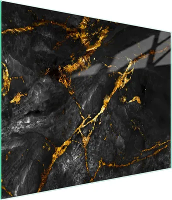 A close-up view of a black marble cutting board with gold veining.