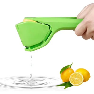 A hand holding a green lemon squeezer with a lemon inside, squeezing juice into water.