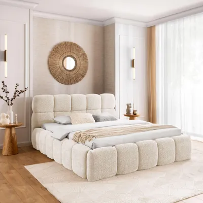A bedroom scene with a bed as the central focus, decorated in neutral tones.