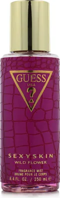 A close-up of a purple fragrance mist bottle with a gold cap and the Guess logo.