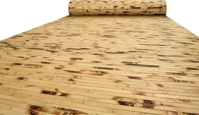 A rolled-up piece of bamboo laminate flooring is shown unrolling onto a surface.