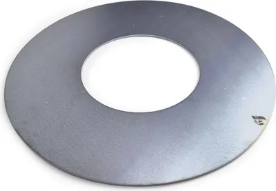 A circular metal plate with a hole in the center, lying on a white background.