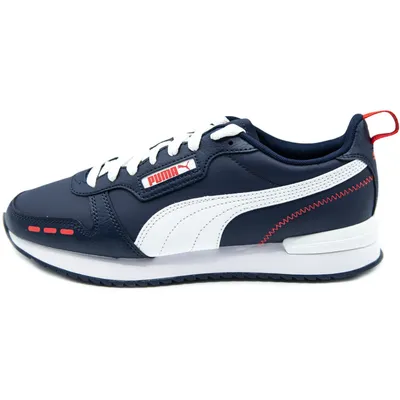 A side view of a single navy blue PUMA sneaker with white accents.