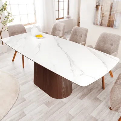A dining room scene with a large marble-patterned table and chairs.