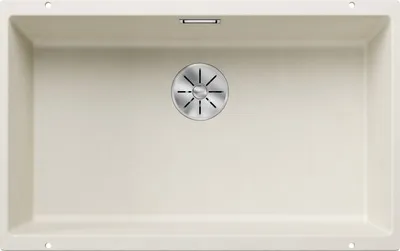 A top-down view of a cream-colored kitchen sink with a silver drain.