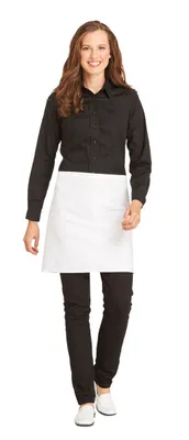 A woman is standing and modeling a black shirt and a white apron.