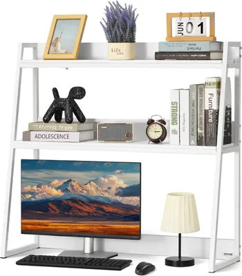 A white bookshelf organizer with various items on its shelves, including books, a picture frame, a plant, a clock, a radio, a computer monitor, a keyboard, a mouse, and a lamp.