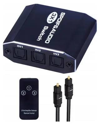 A black audio switch with three input ports and a remote control, along with two optical cables.