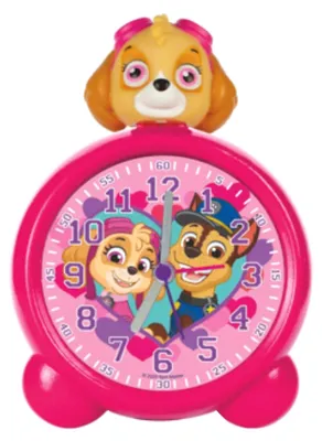 A pink alarm clock with Paw Patrol characters Skye and Chase on the face, and Skye's head on top.