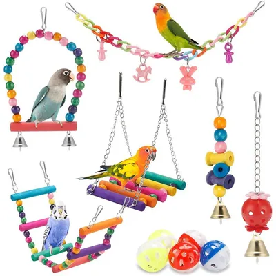 A collection of colorful bird toys, including swings, ladders, and hanging toys, with several birds perched on them.