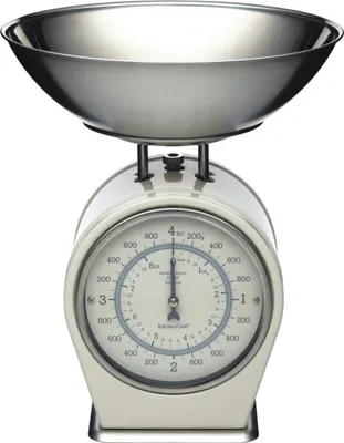 A cream-colored mechanical kitchen scale with a silver bowl on top, set against a white background.