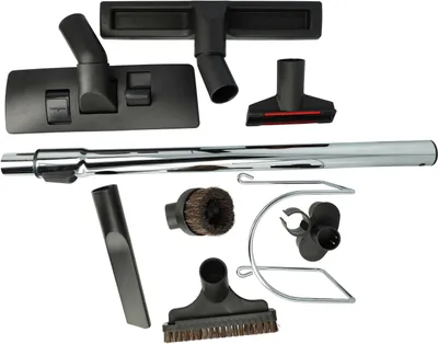 A collection of vacuum cleaner attachments and a metal extension tube are arranged on a white background.