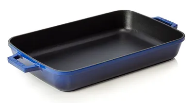 A blue cast iron baking dish with black interior, shown from a diagonal angle on a white background.