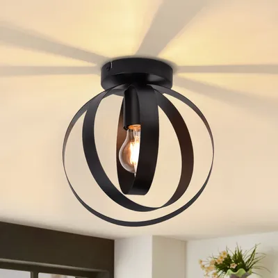 A black industrial-style ceiling light with a spherical metal cage and a visible light bulb.