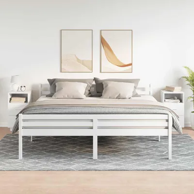 A bedroom scene with a white bed and two white nightstands.