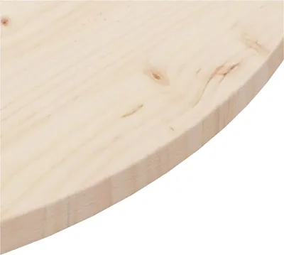 A close-up view of the edge of a round wooden tabletop.
