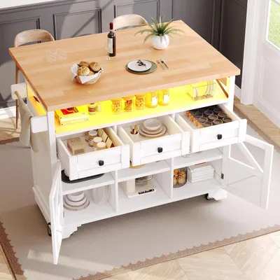 Zdjęcie produktu dla Wózek kuchenny z rozkładanym blatem i oświetleniem LED, 5 kółek, 3 szuflady, 2 drzwiczki, wymiary: 120x43x98 cm, kolor: biały