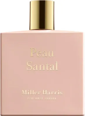 A front view of a pink perfume bottle with a gold cap.