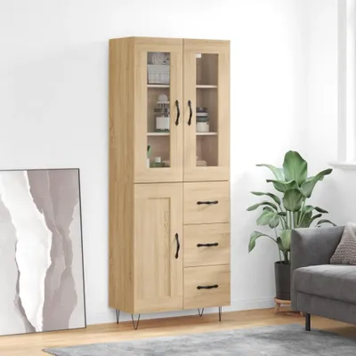 A tall, narrow wooden cabinet with glass doors and drawers, standing in a room next to a large plant and a framed picture.