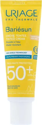 A close-up of a yellow tube of Uriage Bariésun tinted cream with SPF 50+.