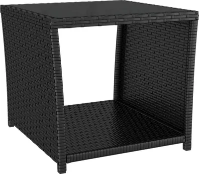 A black poly rattan side table with a glass top and an open shelf.