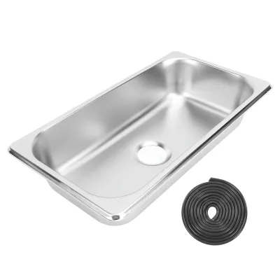 A stainless steel sink and a rolled-up black rubber gasket are shown against a white background.