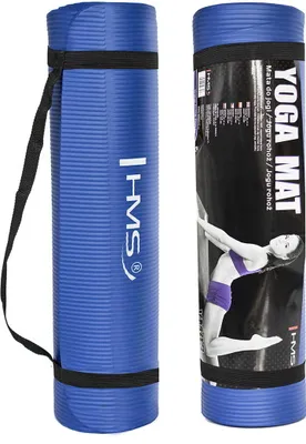 Two rolled-up blue yoga mats are shown side-by-side against a white background. The mat on the left has a black strap and the brand logo 'HMS'. The mat on the right is partially wrapped in packaging that features a woman in a yoga pose and text.