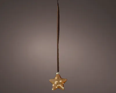 A star-shaped ornament with LED lights hanging from a string against a plain background.