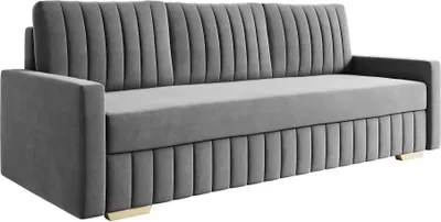 A gray sofa with a channel-tufted back and base, and gold-colored feet.