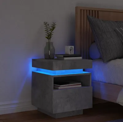 A modern bedside table with LED lighting next to a bed.