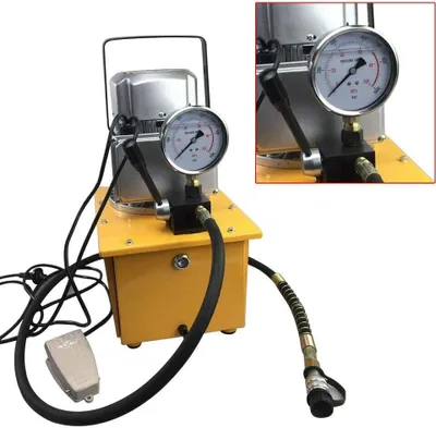 A yellow and silver electric hydraulic pump with a black hose and foot pedal, set against a white background.