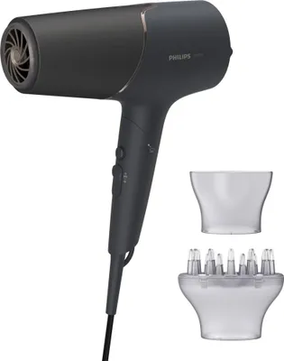 A dark gray Philips hair dryer with two clear attachments on a white background.