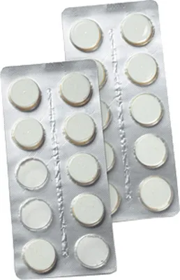 Two blister packs of white tablets, likely for cleaning a coffee machine.