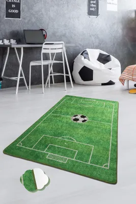 A child's room with a football-themed rug, beanbag chair, and desk.
