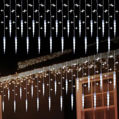 Icicle lights are strung along the eaves of a house and a balcony.
