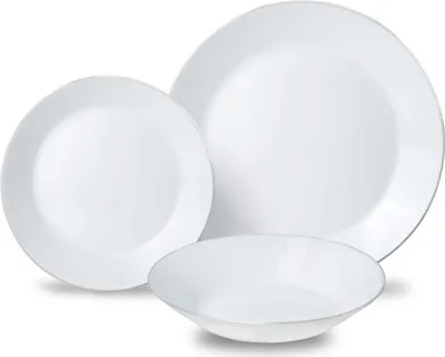 A set of white ceramic dishes arranged on a white background.