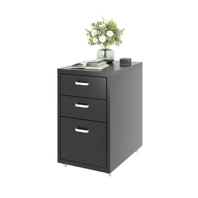 A dark gray, three-drawer filing cabinet with silver handles, topped with a book, a small square object, and a vase of white flowers.
