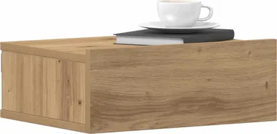 A wooden floating nightstand with a book and a cup of coffee on top, set against a white background.