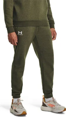 A man is wearing green jogging pants and sneakers.