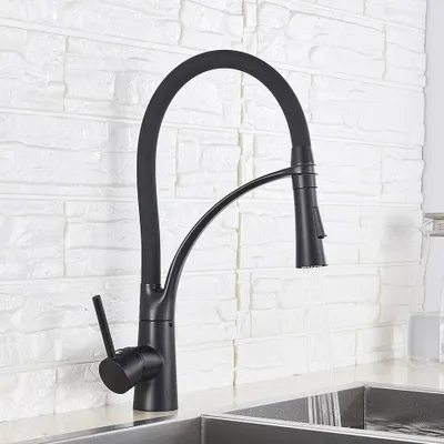 A black kitchen faucet with a flexible hose is shown in use, with water running into a sink.