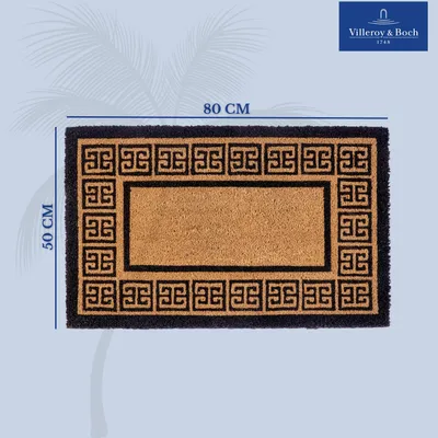 A doormat with dimensions indicated, placed on a light blue background with palm leaf graphics.
