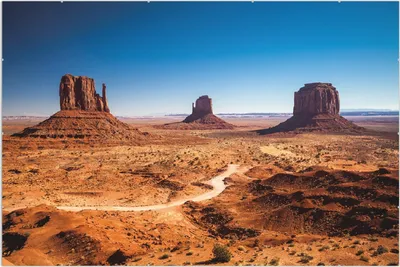 Produktbild von Wallario Wandbild Monument Valley unter blauem Himmel, Größe: 61 x 91,5 cm, Poster mit rahmenlosen Bildhalter