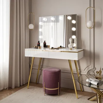 A modern vanity table with a lighted mirror and a stool in a well-decorated room.