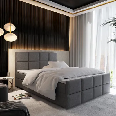 A luxurious bedroom scene featuring a large bed with a grey upholstered headboard and base, dressed in white bedding. The room has a modern, sophisticated aesthetic with dark wood paneling on the wall, ambient lighting, and sheer curtains.