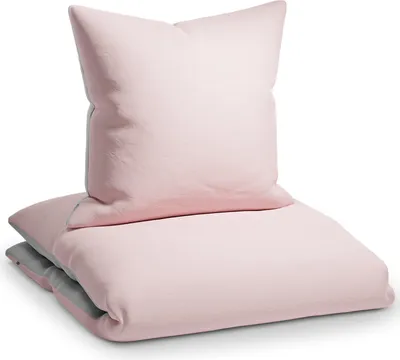 A pink pillow and folded duvet cover are stacked on a white background.