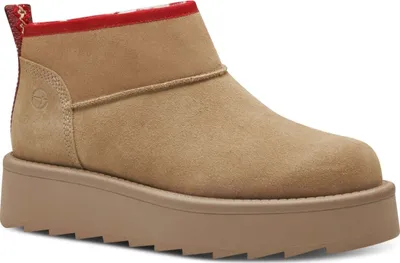 A single tan boot with a red trim and a thick platform sole is shown against a white background.