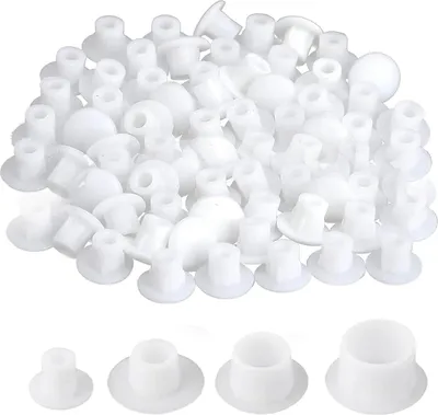 A large pile of white plastic hole caps, with four individual caps shown in detail at the bottom.