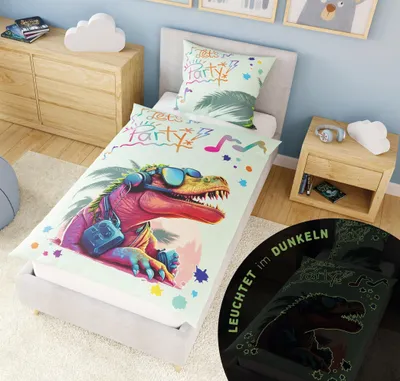 A child's bedroom with a bed featuring dinosaur-themed bedding.